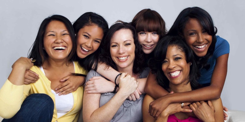 group of women hugging and smiling together